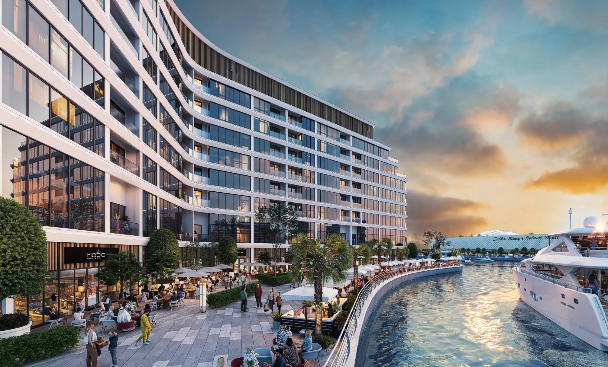 Render at sunset of a curved apartment block above a promenade of cafés, with a yacht moored on the canal and the Sobha Siniya Island Mall beyond