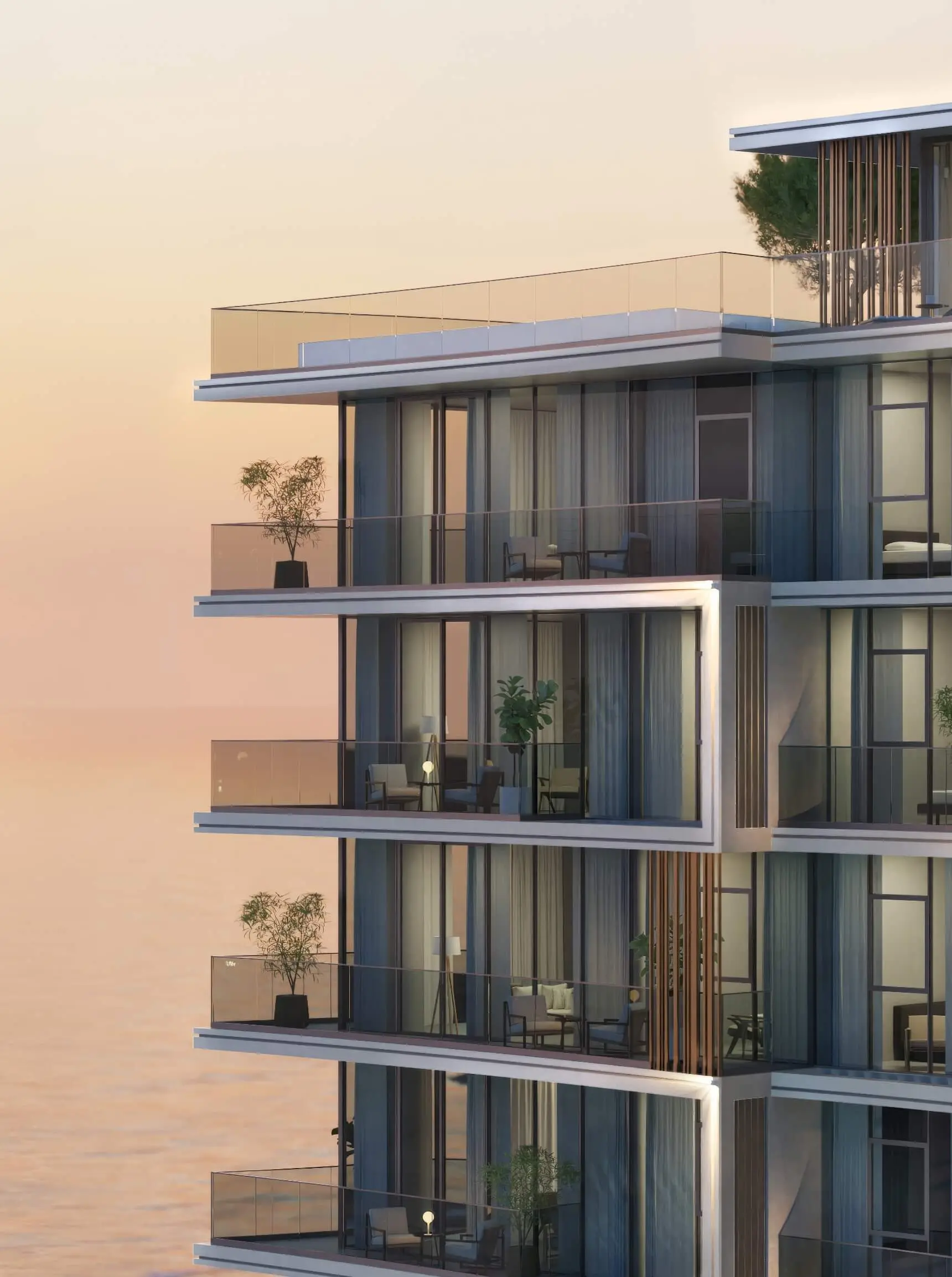 Render of a corner of the building at sunset: stacked glass balconies with chairs and potted trees, the sea behind