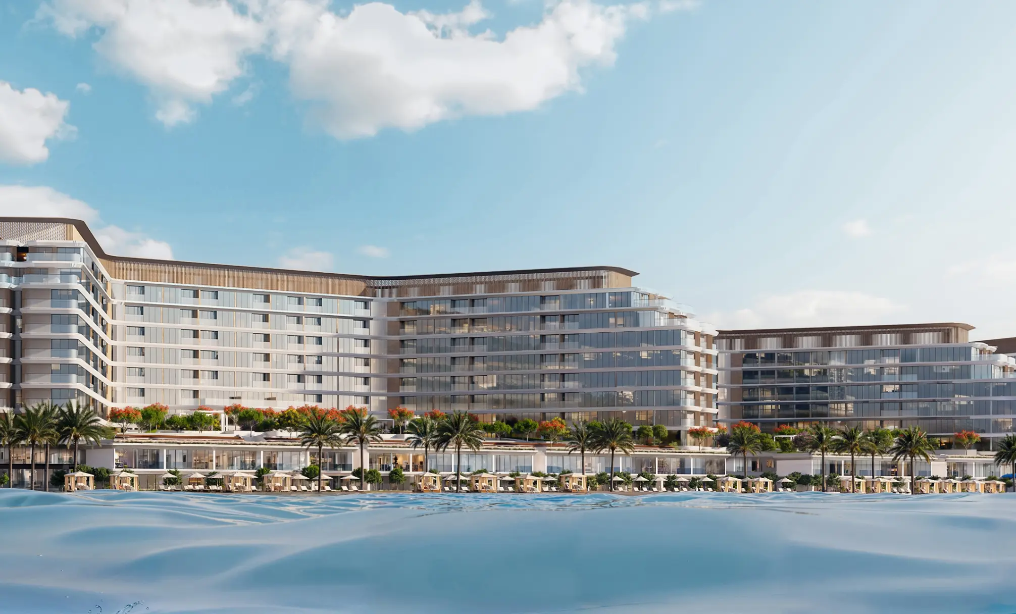 Render of Coraline's apartment blocks seen from the water, with a low row of homes and cabanas along the beach in front