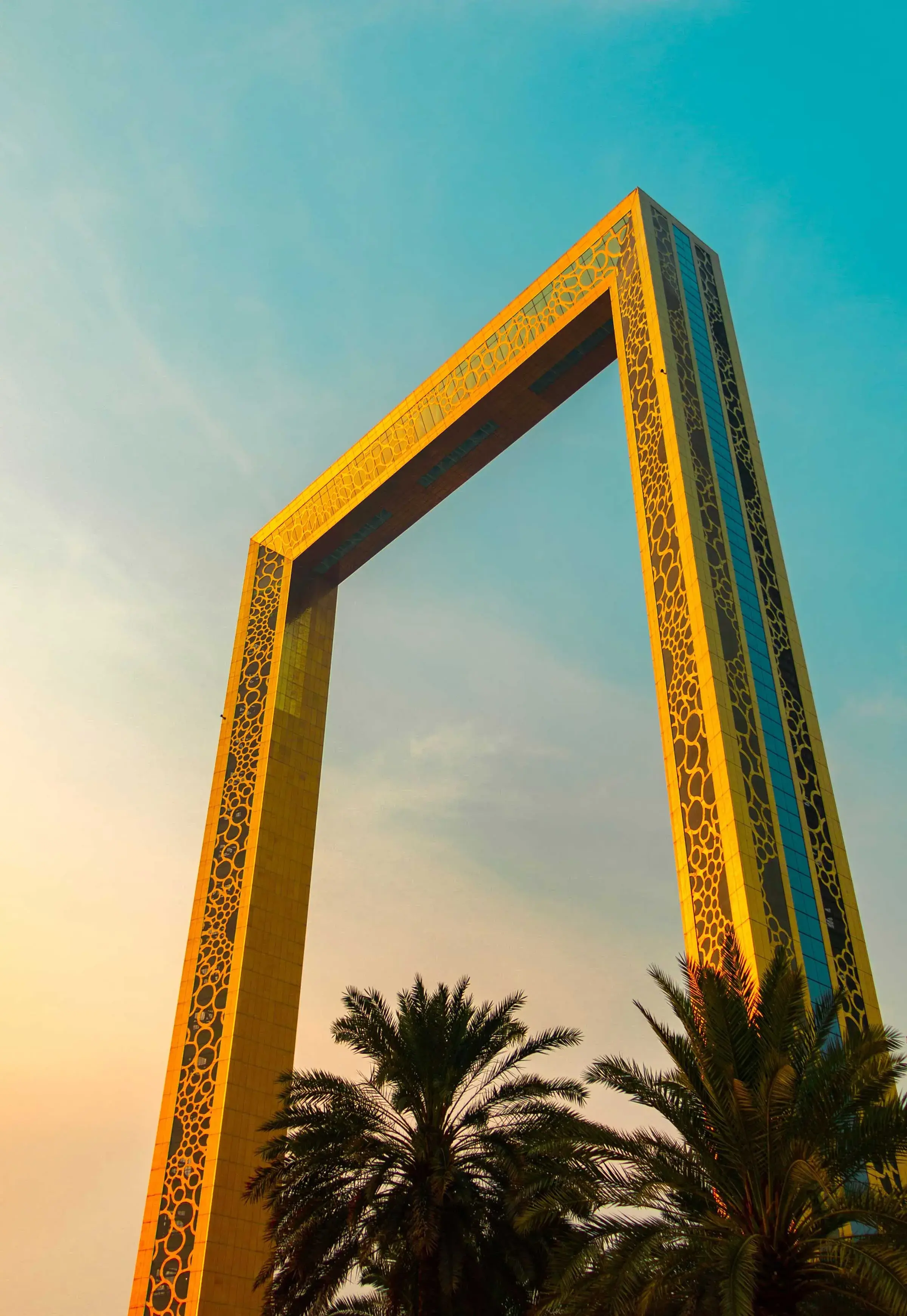 The golden Dubai Frame towering against a clear sky.