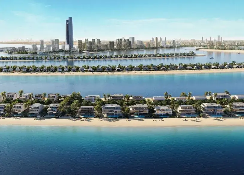 Aerial view of a waterfront city with marina and skyscrapers.
