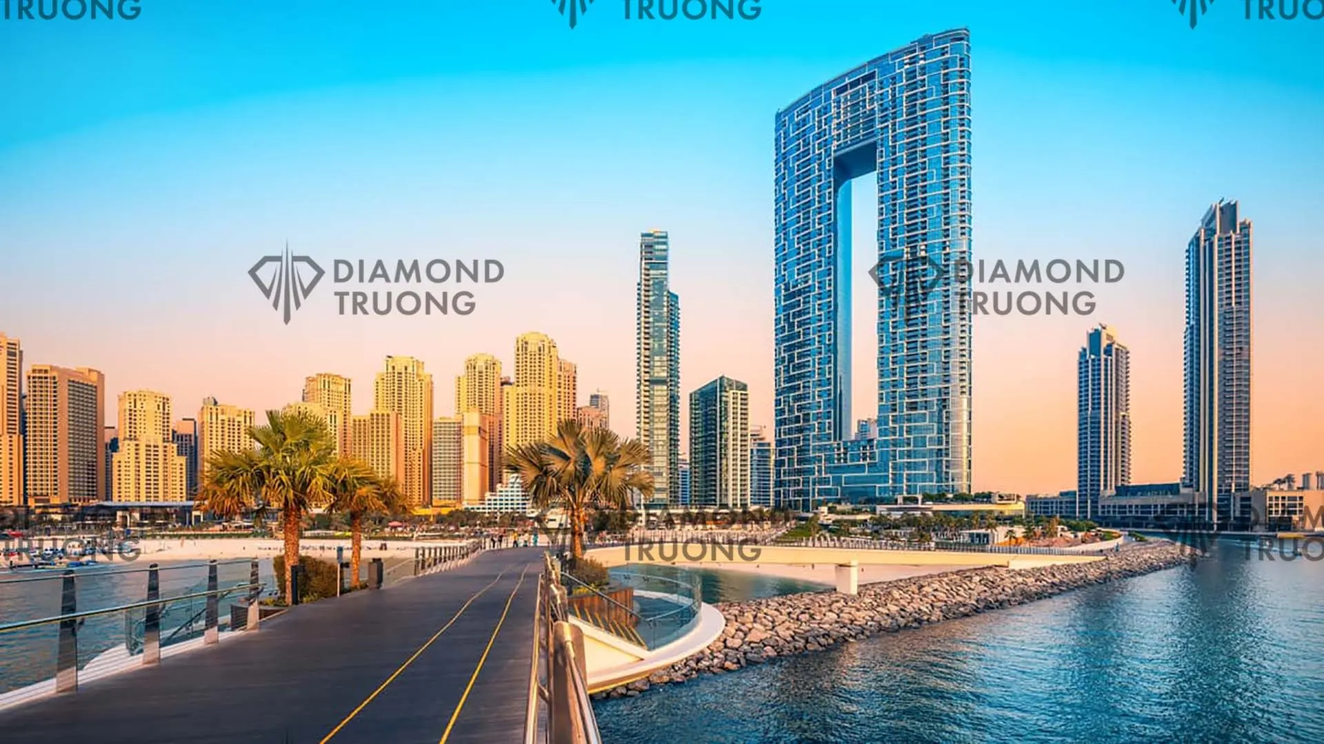 JBR beach and towers seen from a waterfront walkway, with the arched Address Beach Resort tower