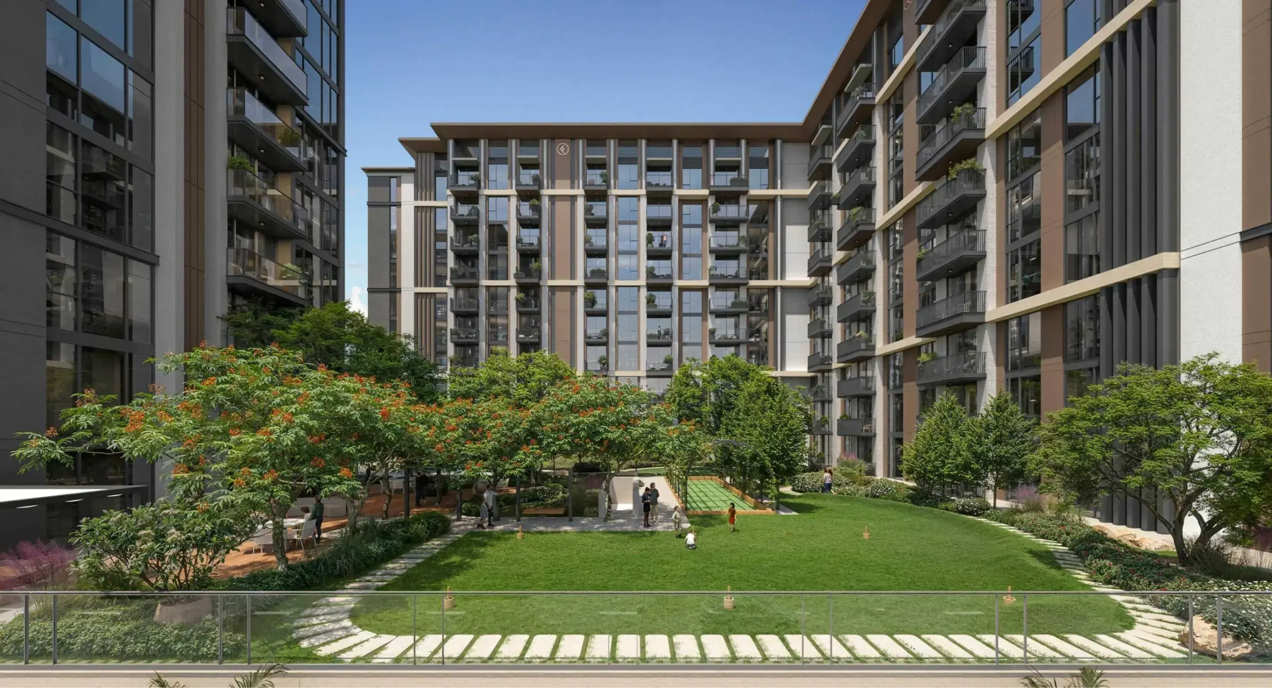 Ellington's render of Windsor House in Dubai South: a courtyard lawn with trees and a play area between apartment blocks