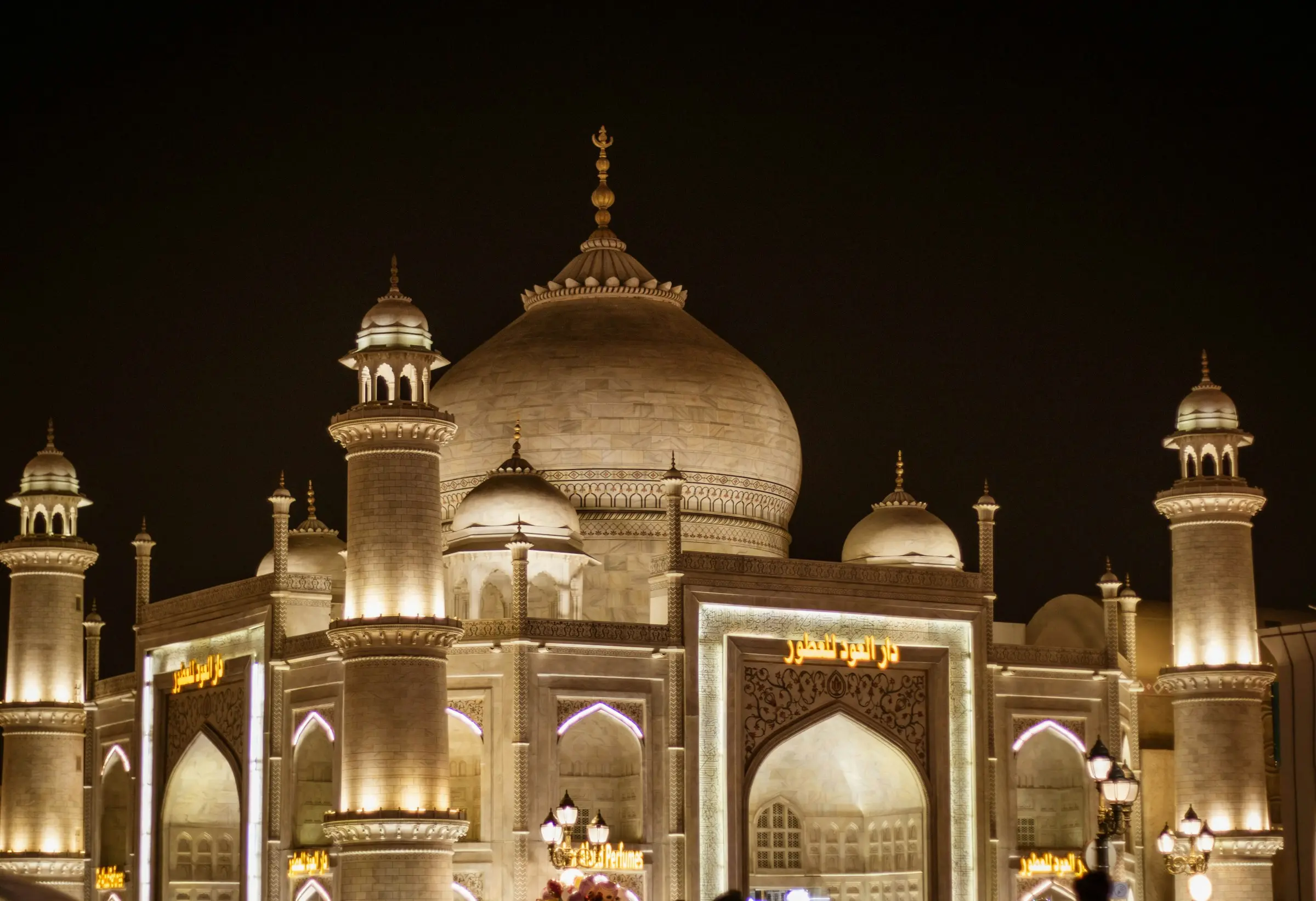 A domed, Taj Mahal-style pavilion lit up at night at Global Village