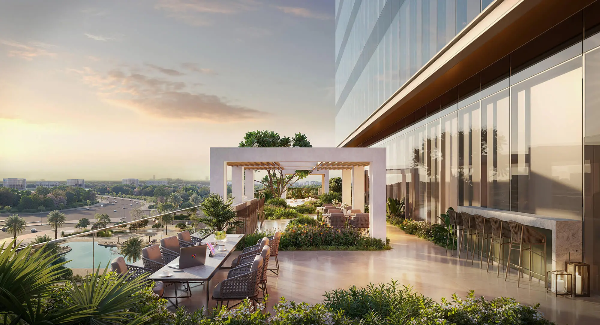Render of a shaded terrace with dining tables and a pergola beside the glass tower, a lagoon and a highway below
