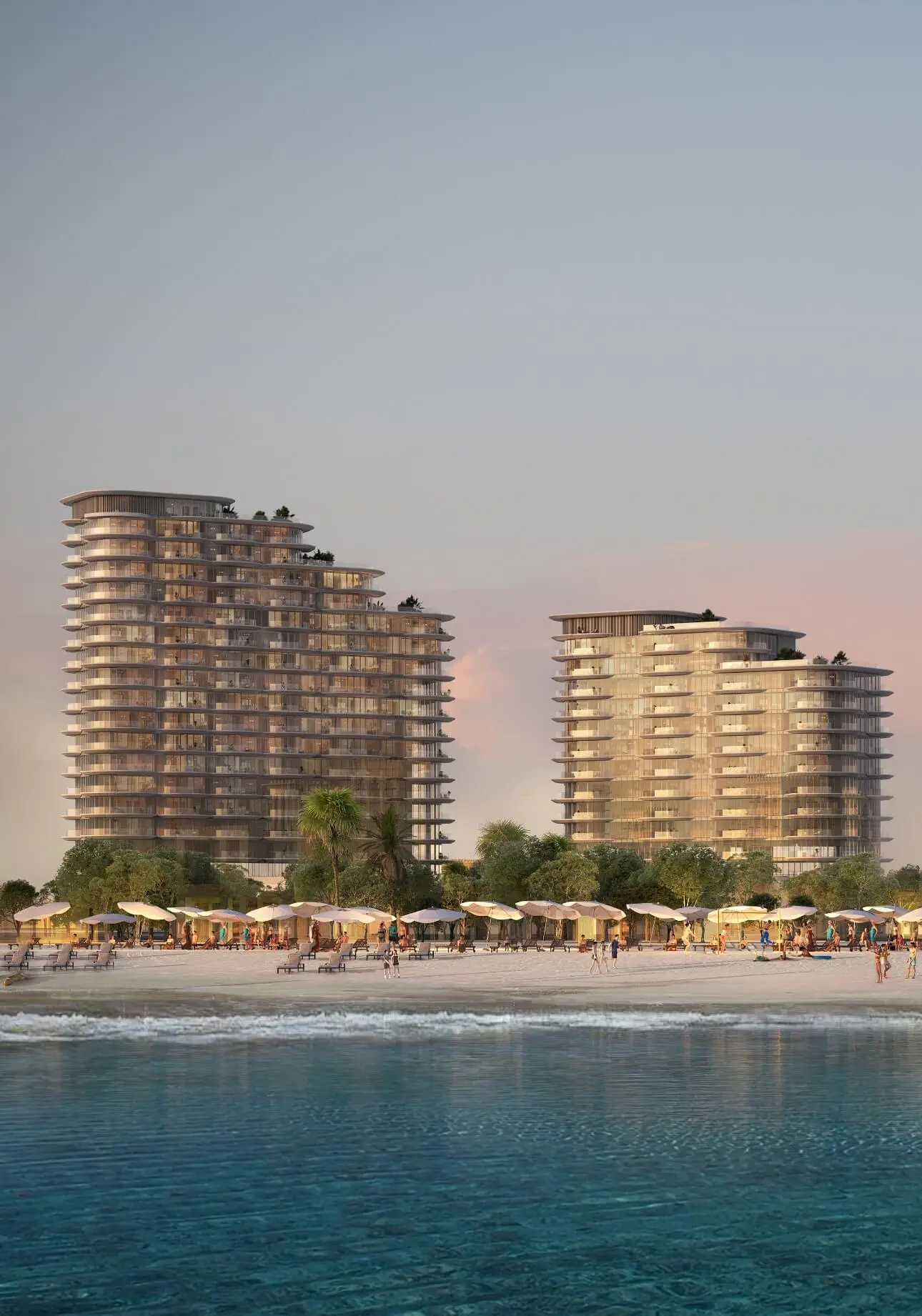 Render of two towers with curved balconies at dusk, behind a beach lined with parasols, seen from the water