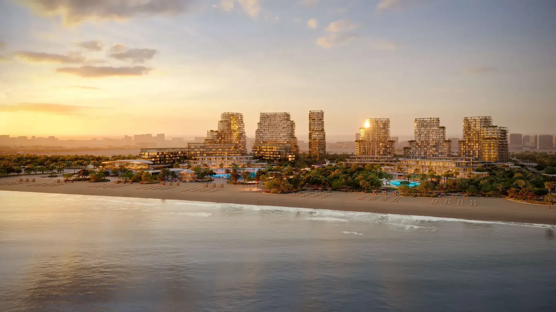 Beyond's render of its Hado project on Dubai Islands: stepped glass towers with planted terraces behind a beach, loungers and pools at sunset