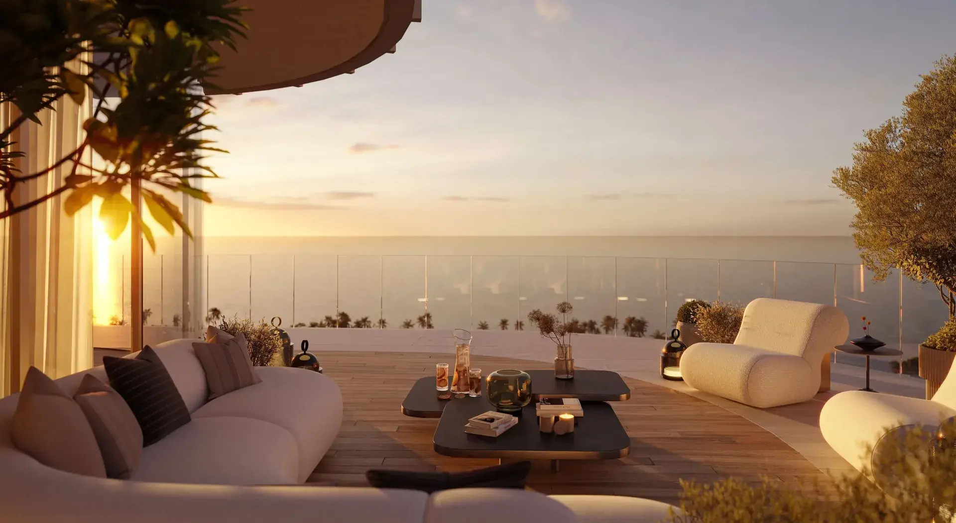 Render of a terrace at sunset with low sofas and a coffee table, facing the sea behind a glass balustrade