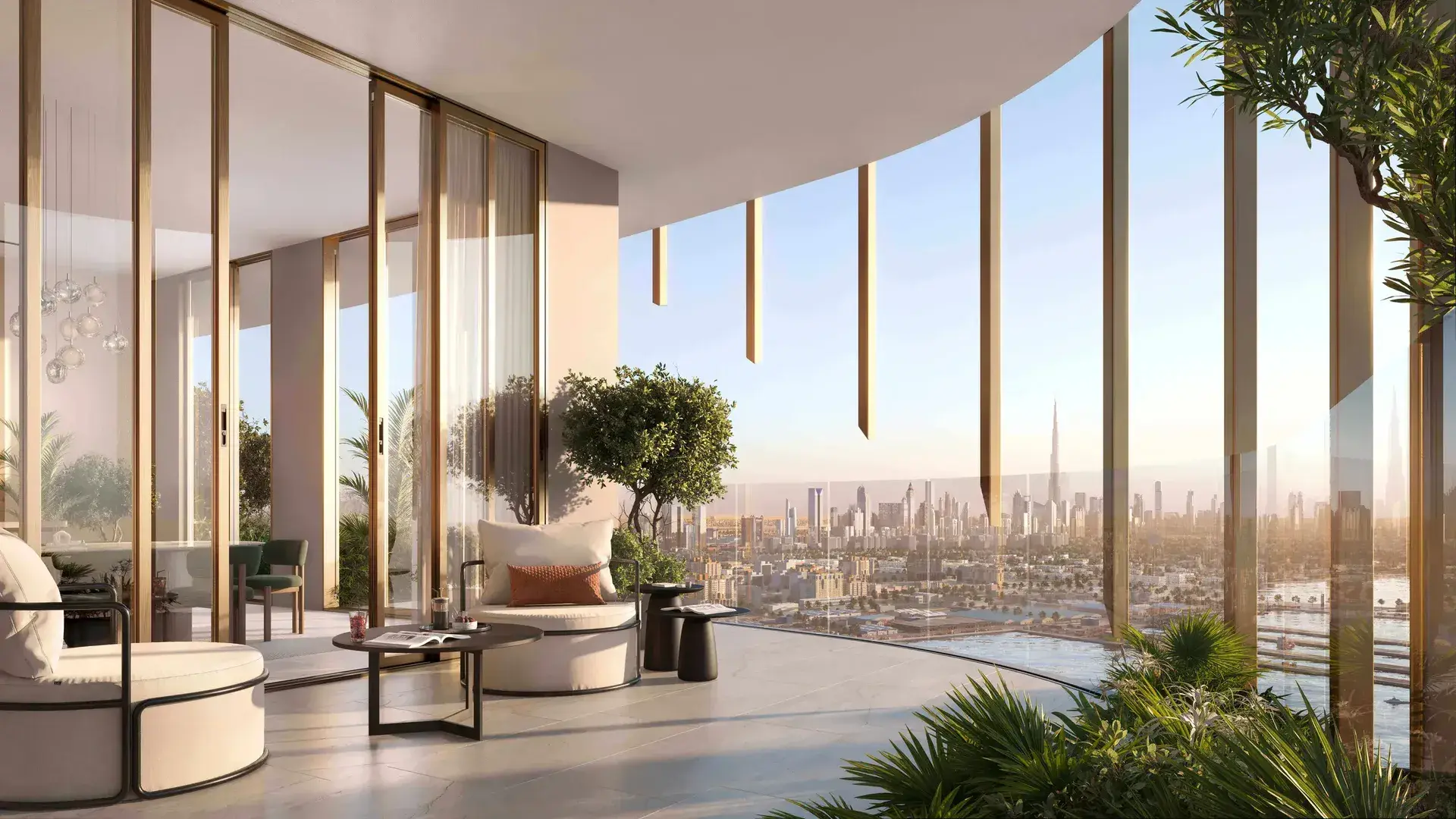 Render of a curved balcony behind slim gold fins, with armchairs and potted trees, looking over the city to Burj Khalifa