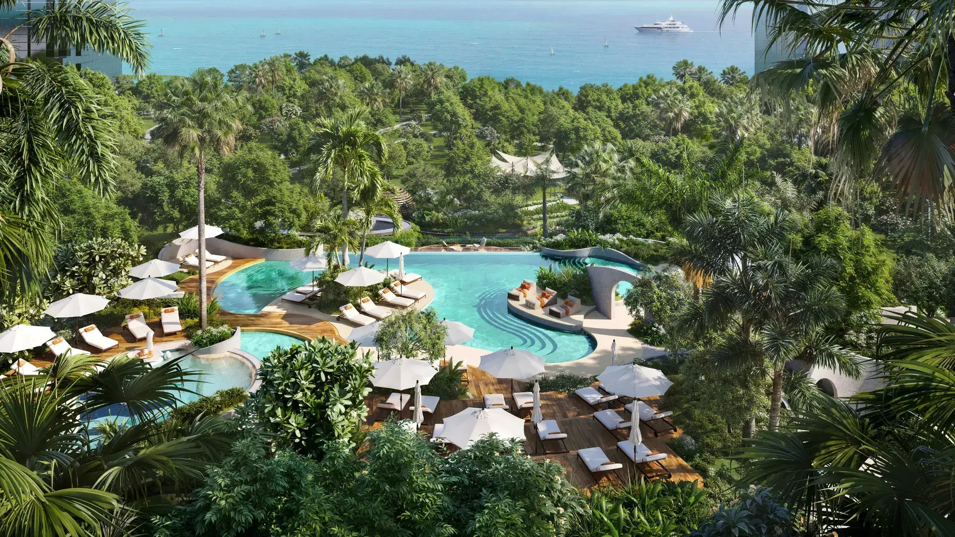 Render of a lagoon-style pool with loungers and parasols among palms, the sea and a yacht beyond