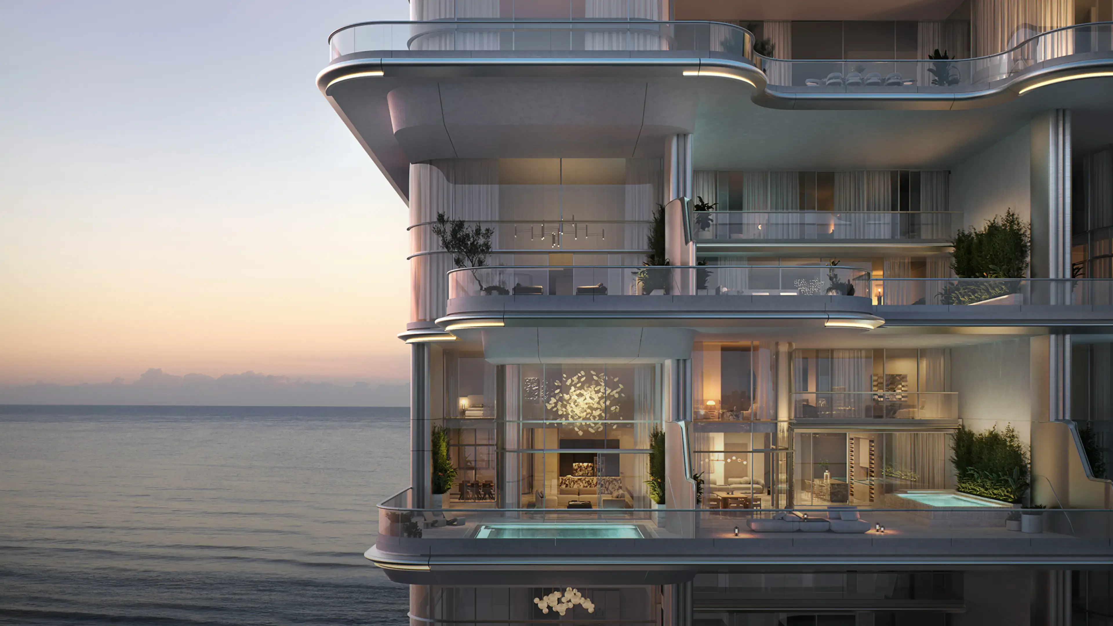 Render of a two-storey Orla residence at dusk: a chandelier in the double-height living room and plunge pools on the terraces facing the sea
