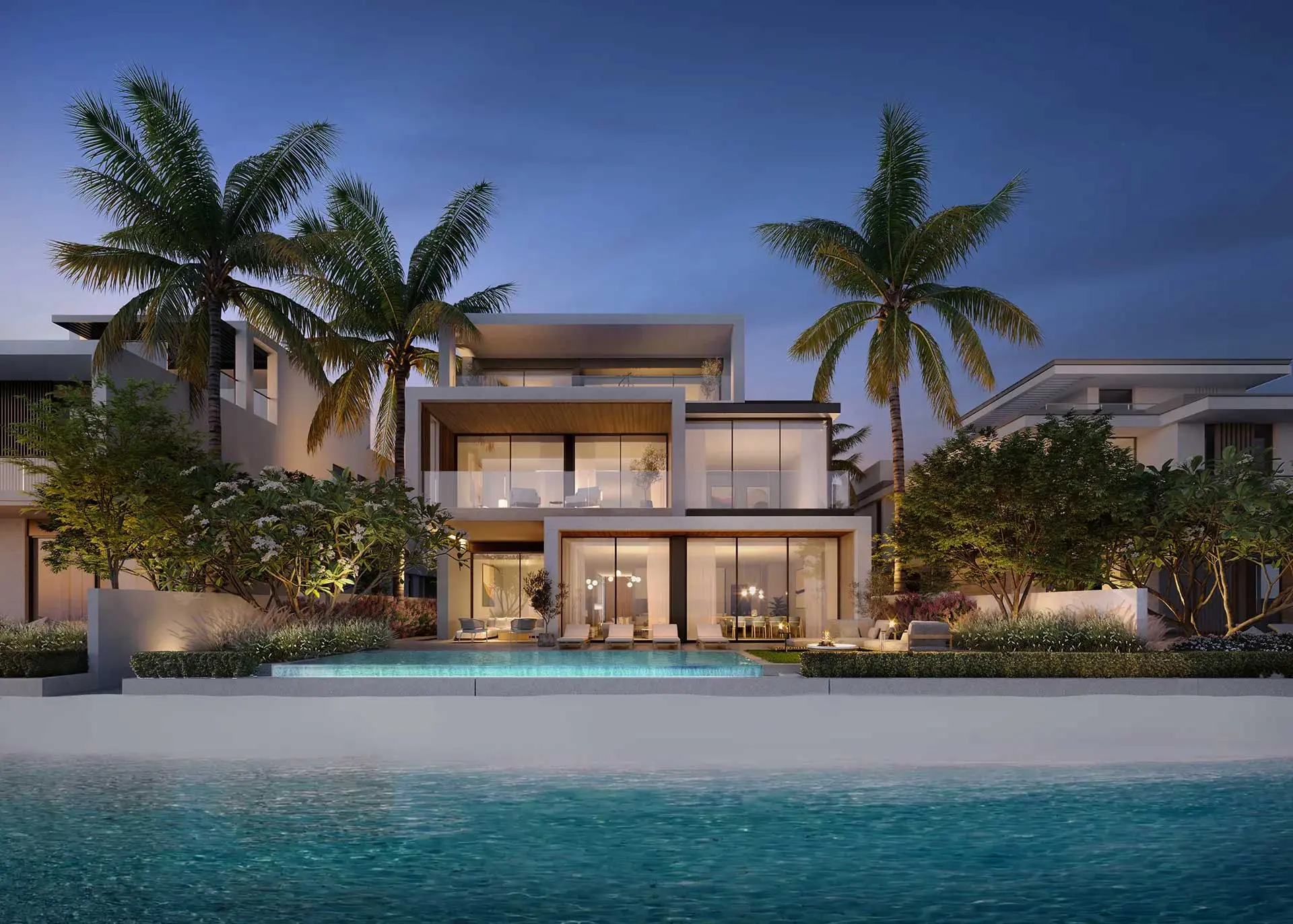 Nakheel's render of a Palm Jebel Ali beach villa at dusk: a lit two-storey house with a pool, palms and the sea in front