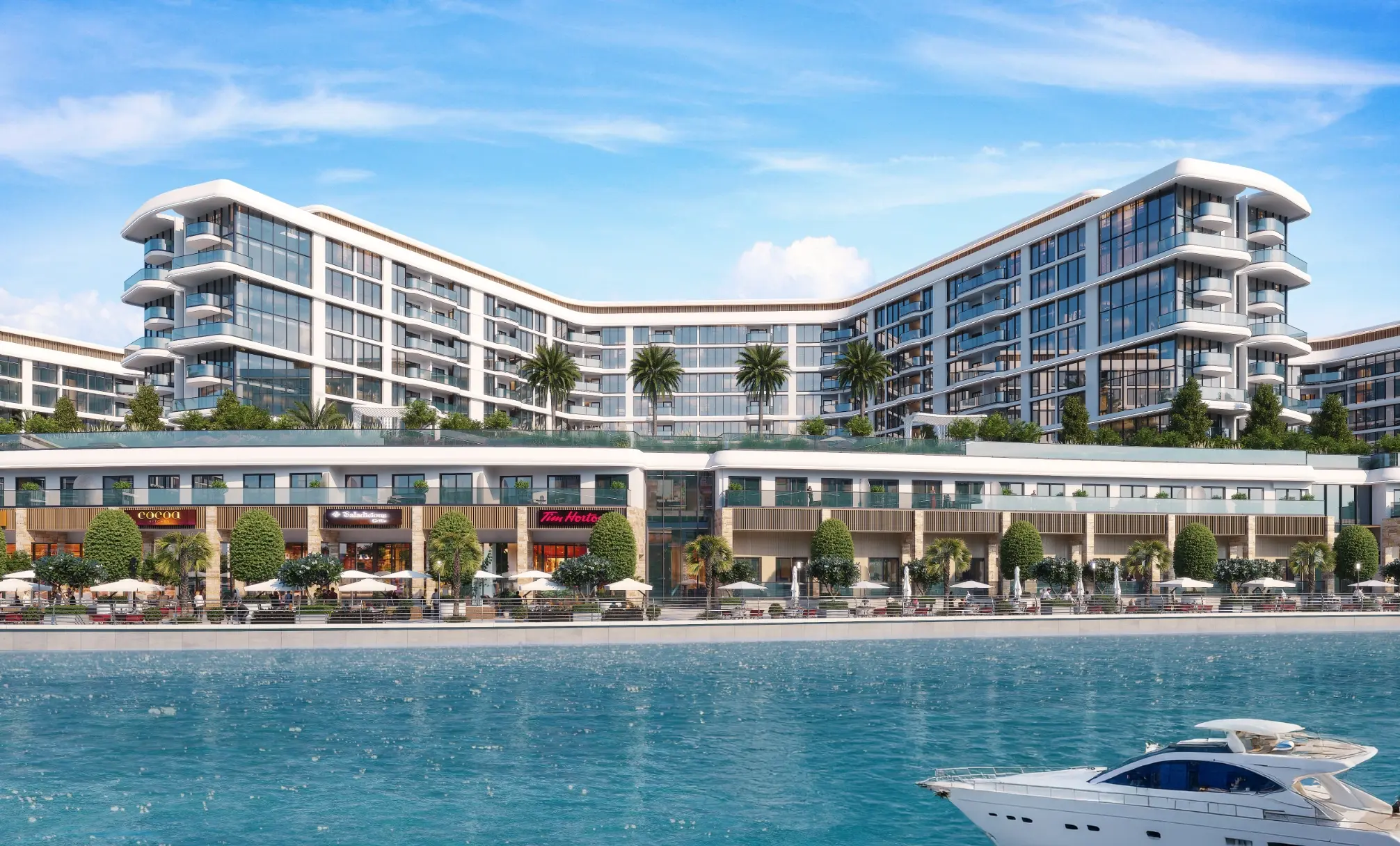 Render of a V-shaped mid-rise block with curved corner balconies above a two-storey arcade of shops and cafés, seen across the marina