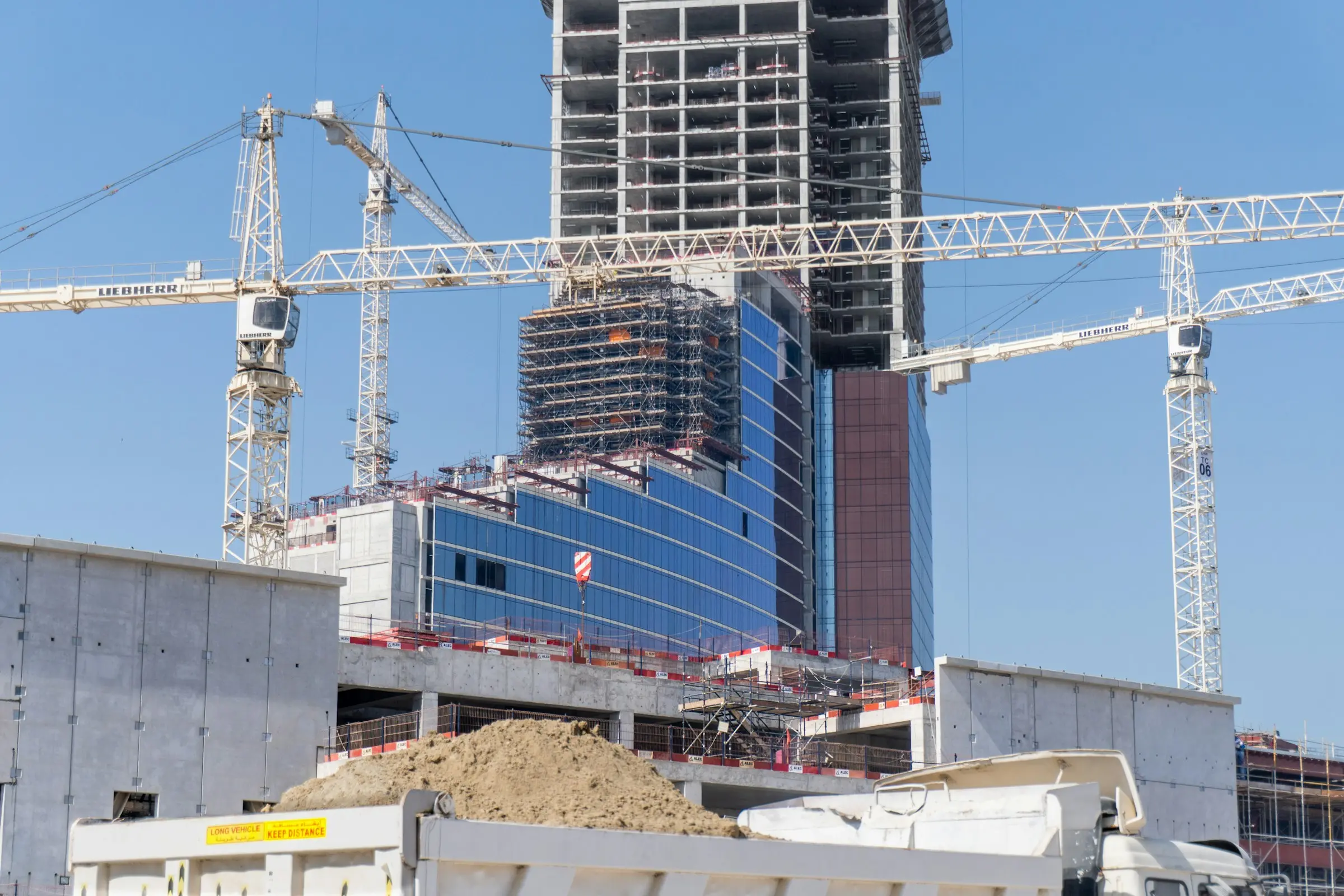 Towers under construction on Al Marjan Island, with tower cranes overhead