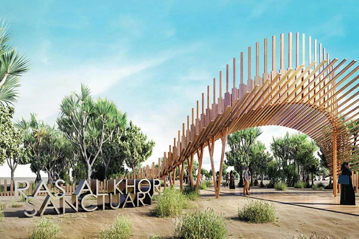 Render of a timber-arch entrance with a Ras Al Khor Sanctuary sign, among trees and desert shrubs