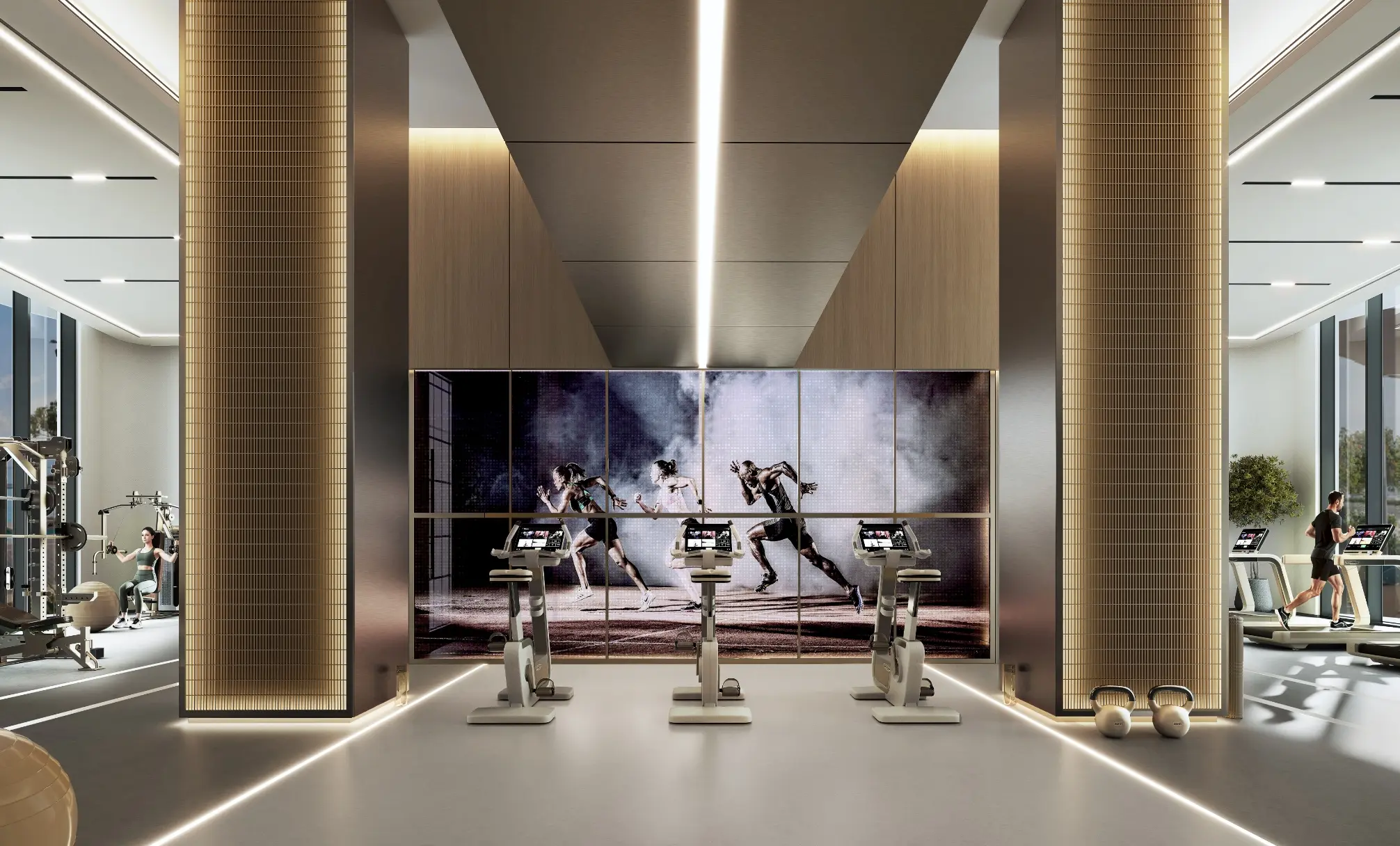 Render of a gym with exercise bikes facing a video wall, with weights and treadmills on either side