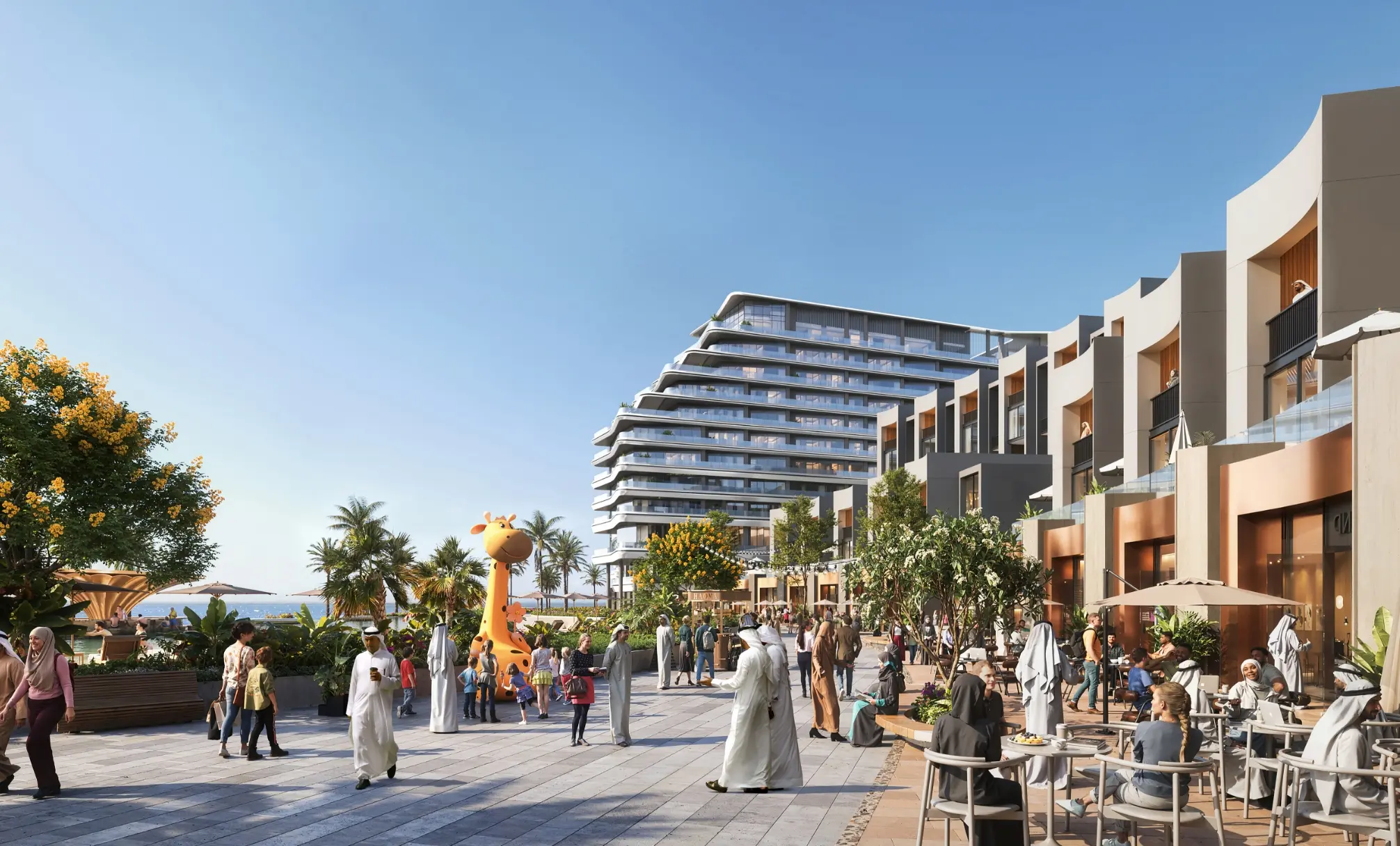 Render of a paved promenade with café tables, palms and a giraffe sculpture between low-rise shops and a tower