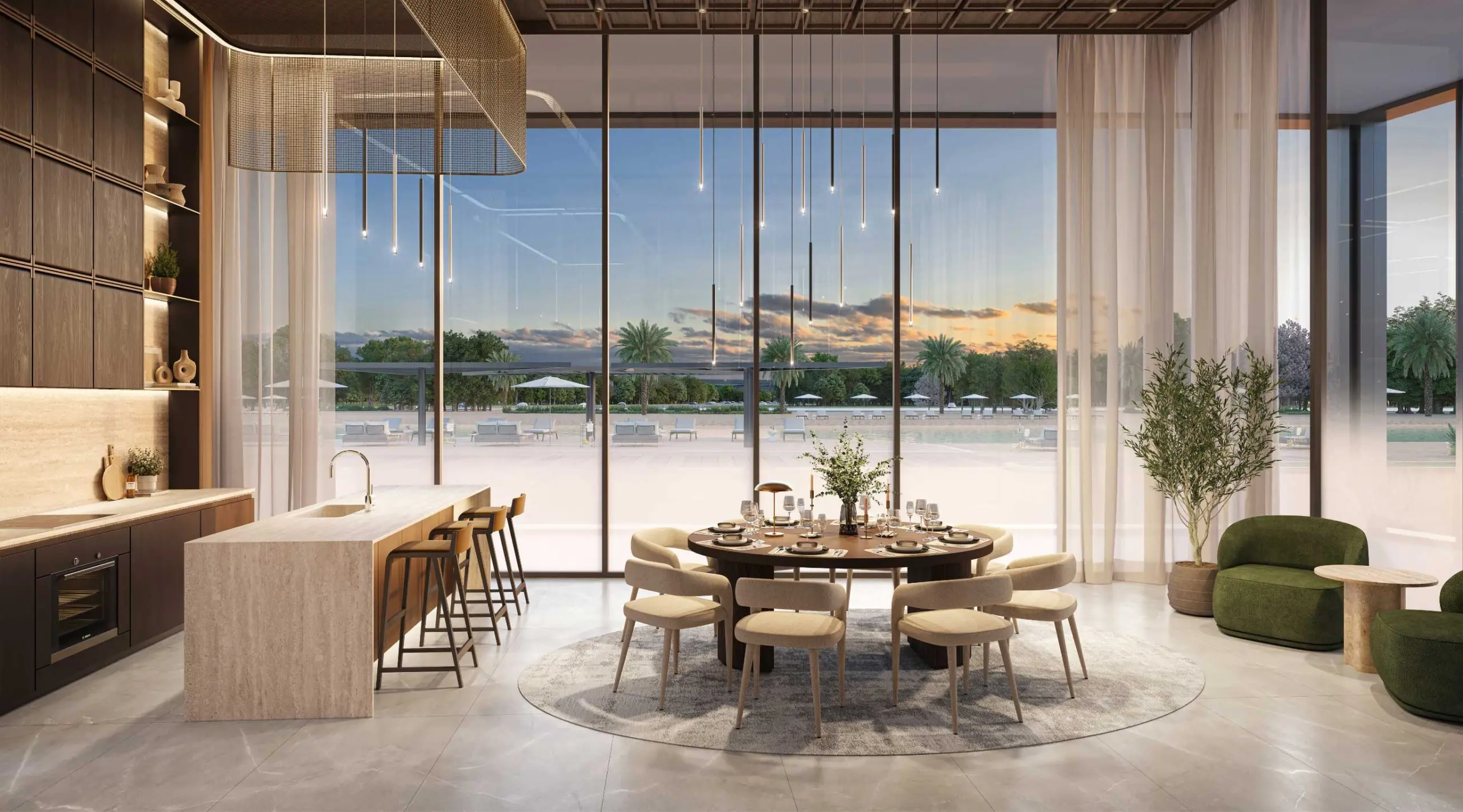 Render of the Supper Club: a stone kitchen island with bar stools, a round dining table and full-height glass onto water and palms at dusk