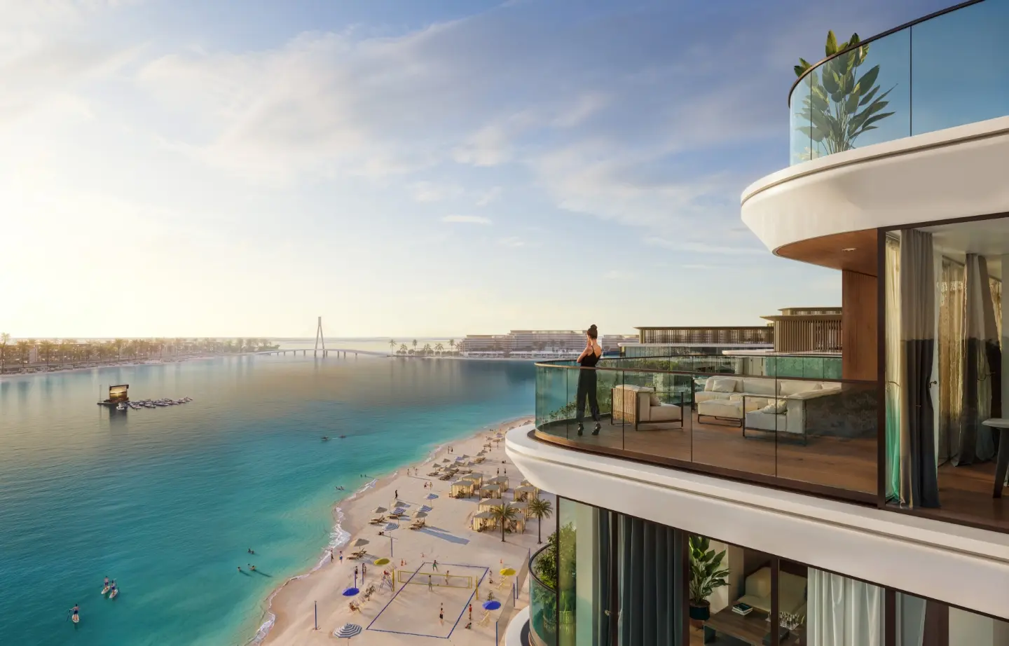 Render of a woman on a curved glass balcony above a busy beach, with turquoise water and a cable-stayed bridge in the distance