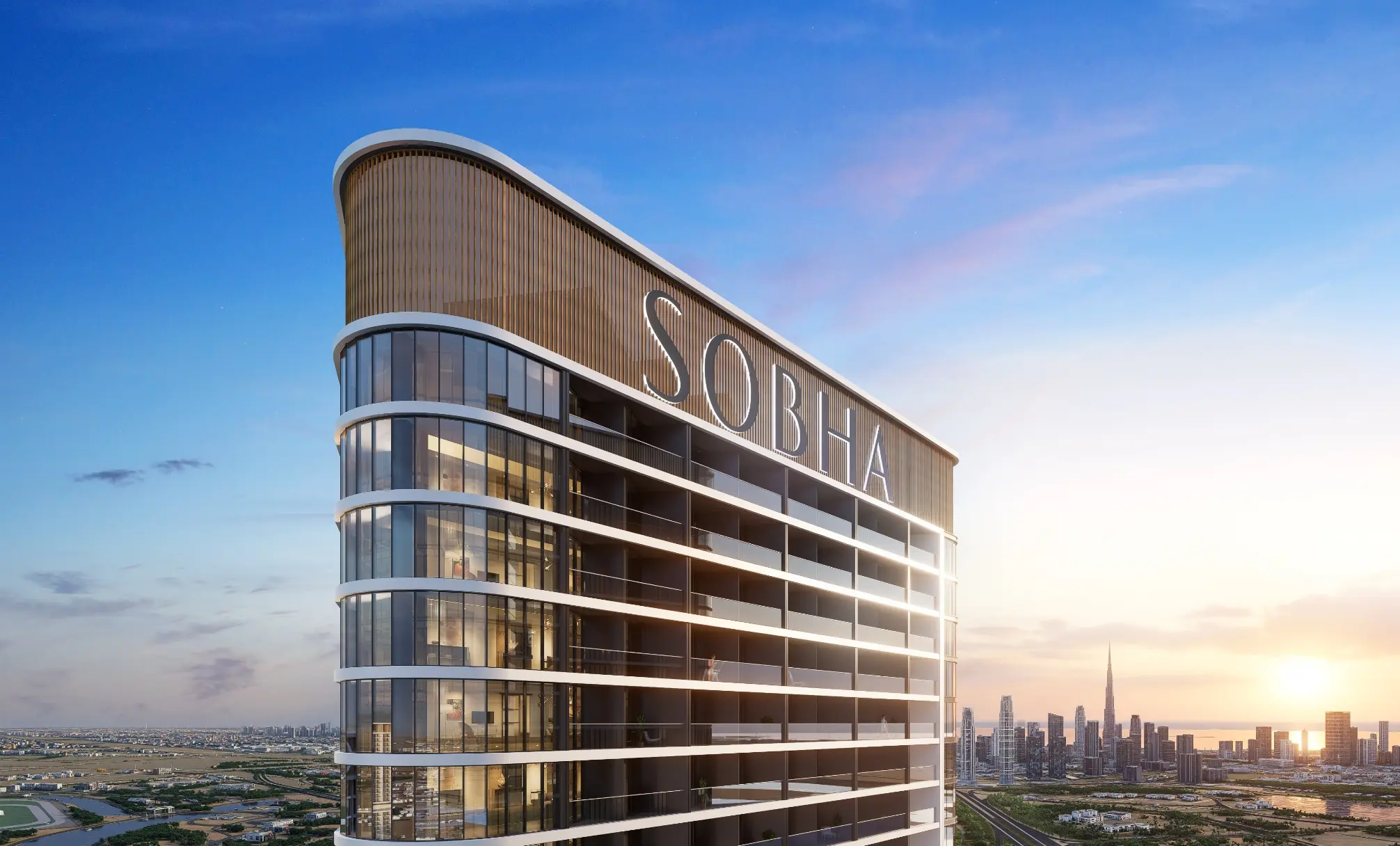Render of the top of the tower with the Sobha name on its crown, and Burj Khalifa and the Downtown skyline behind at sunset