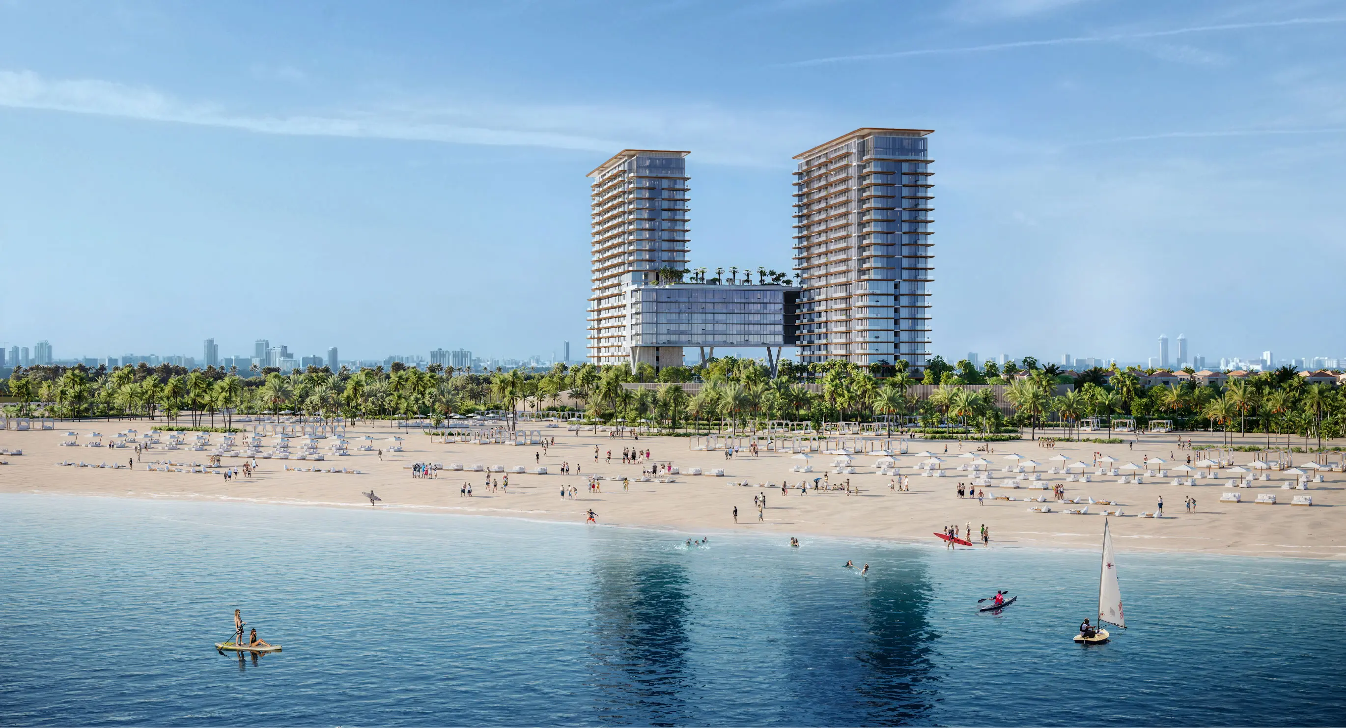 Render of two towers joined by a raised bridge block with palms on its roof, behind a busy beach and calm water