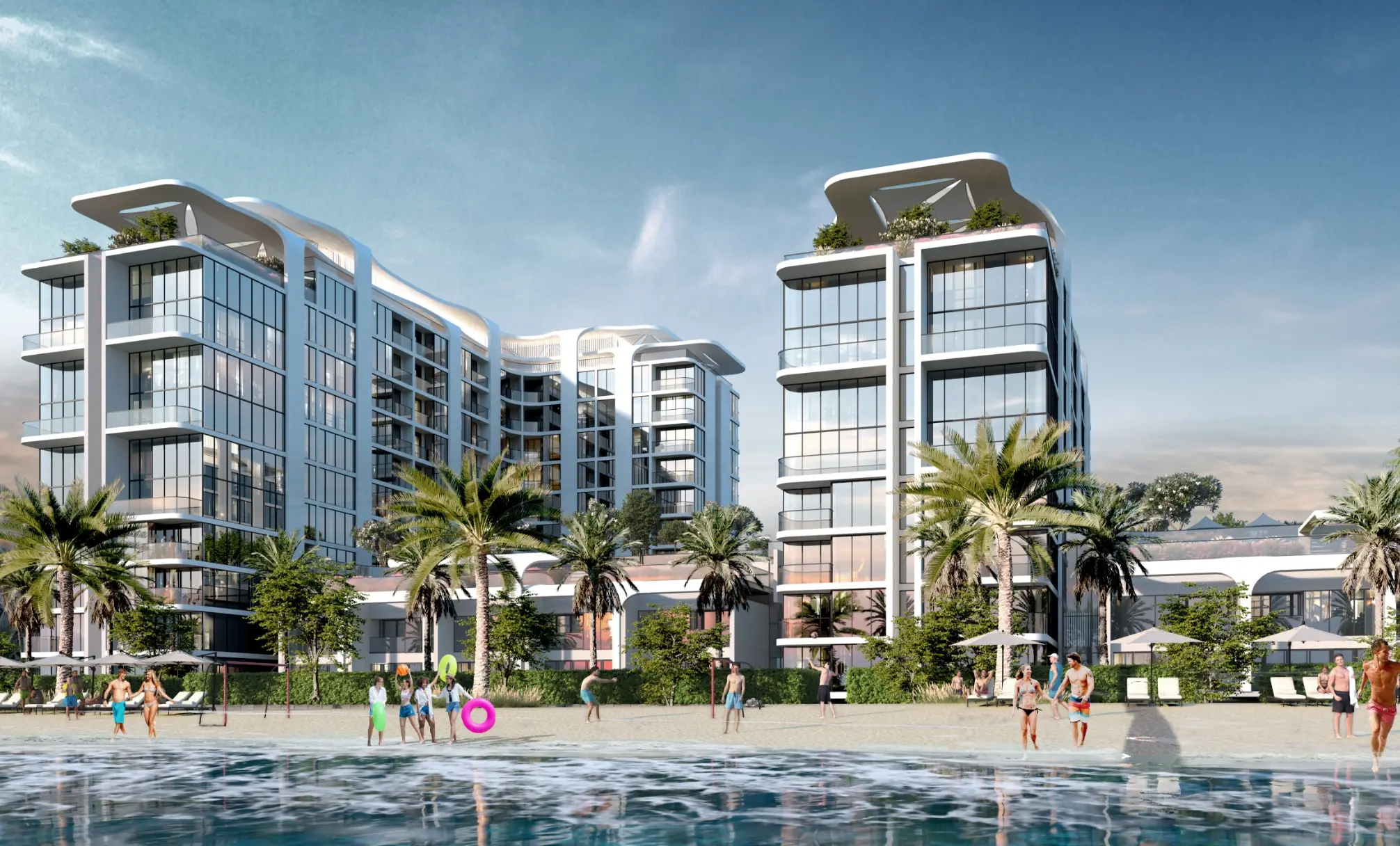 Render of two of the towers from the water's edge, with palms, sun umbrellas and people on the beach