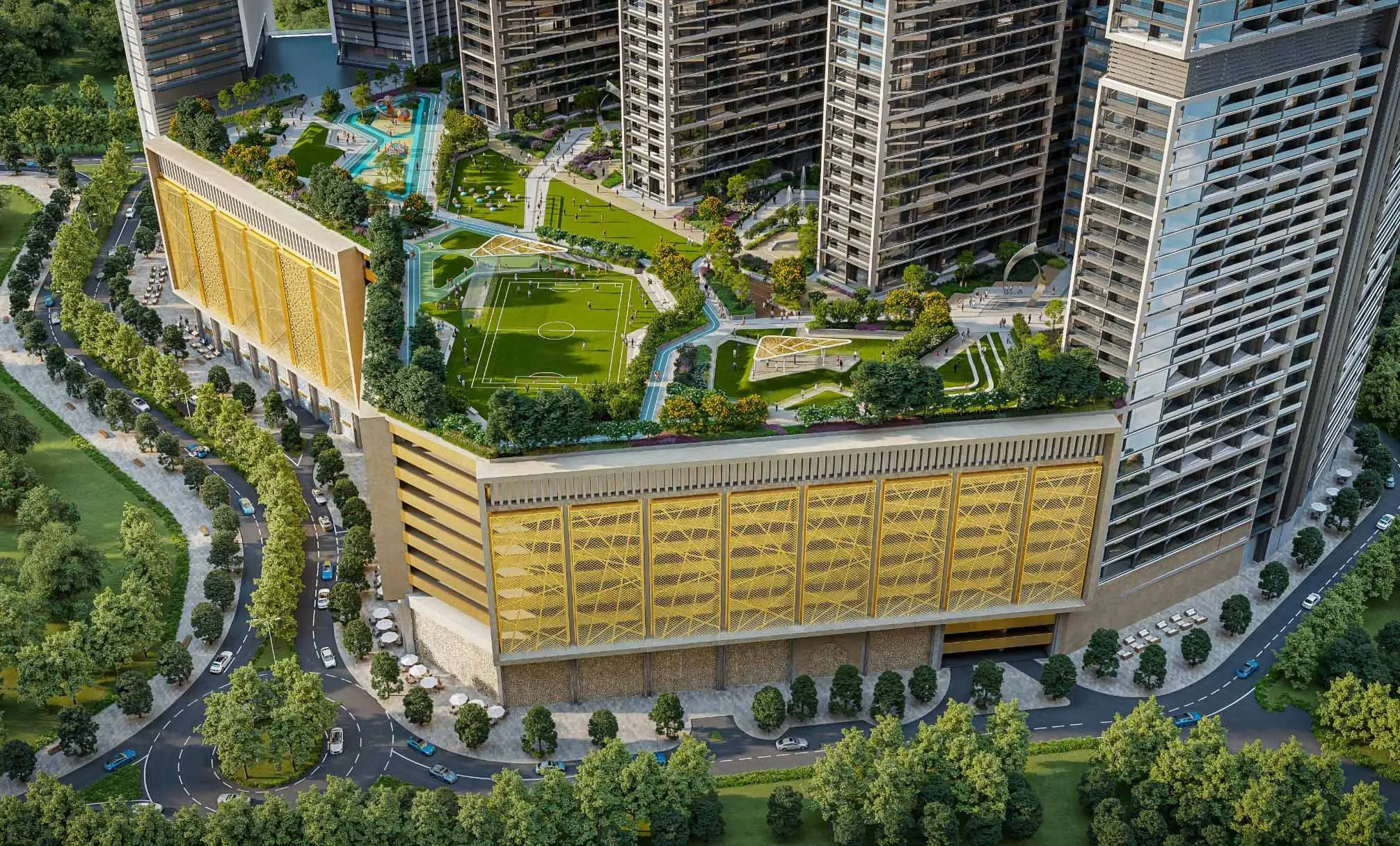 Aerial render of the Sobha Central podium, with a football pitch and gardens on its roof and a gold-screened facade below the towers