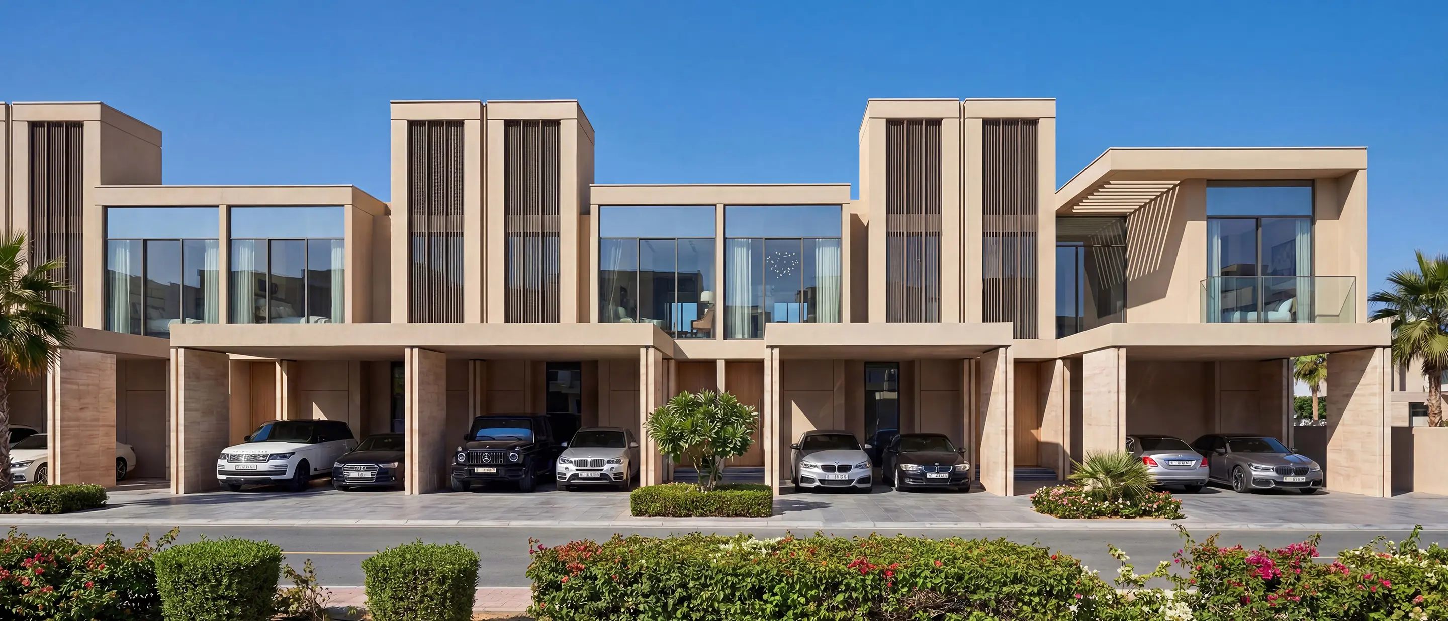 Row of joined sand-coloured villas with slatted upper floors and cars parked under each home, from Sobha's marketing images for Sobha Sanctuary
