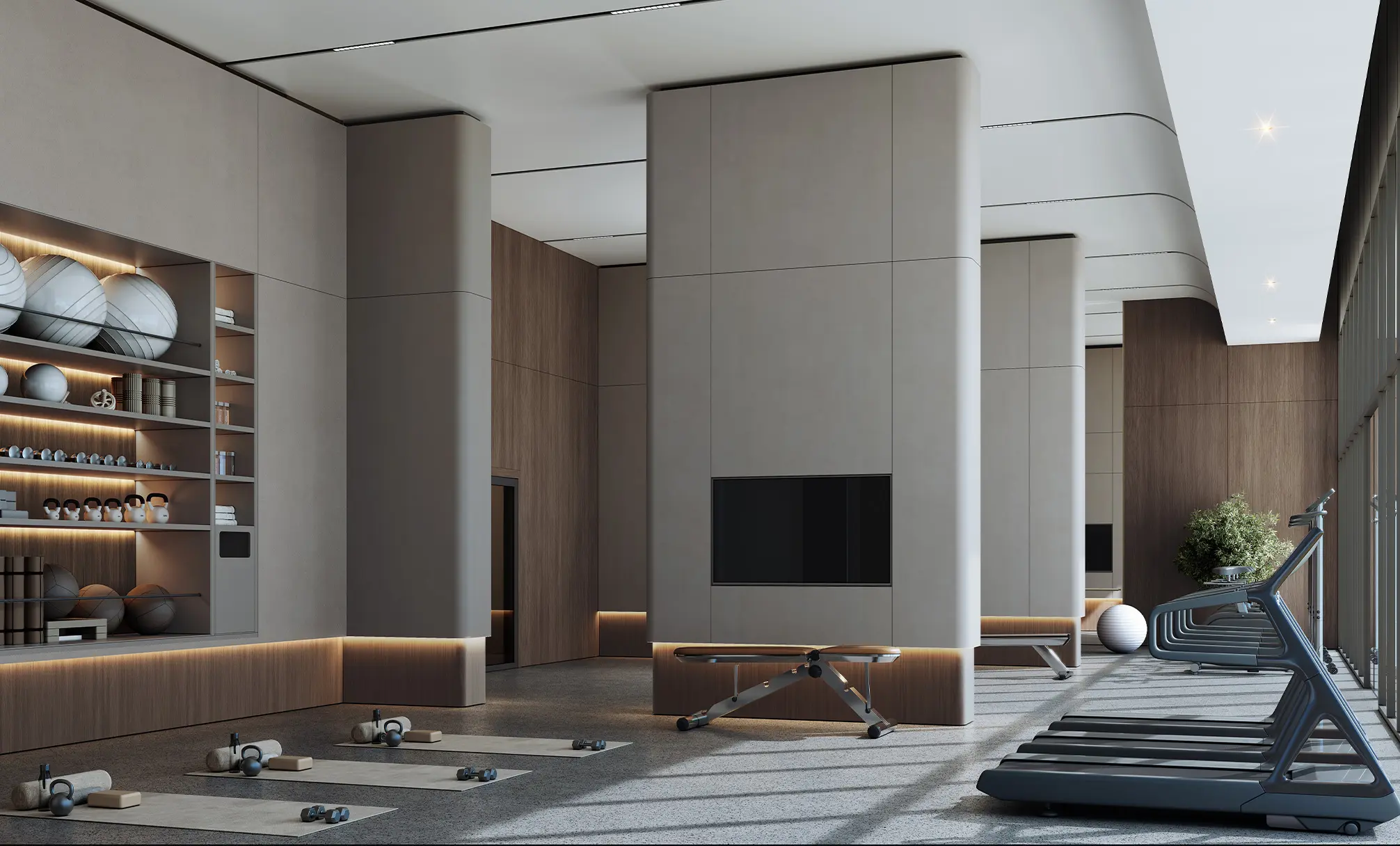 Render of a gym with a treadmill, weight benches, exercise balls on shelves and a wall-mounted screen