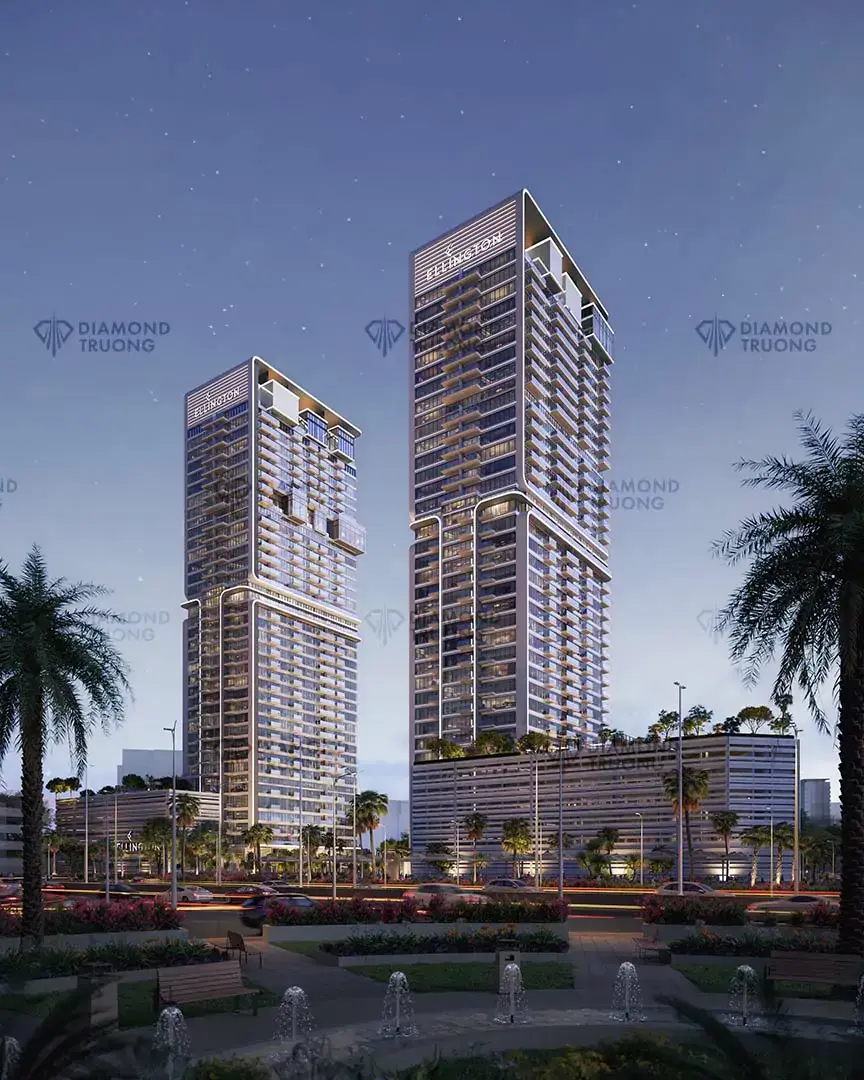 The two UH towers at night, with gardens and palm trees in front
